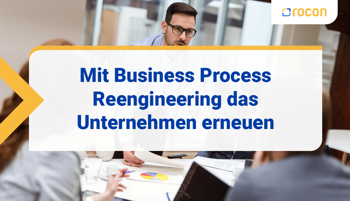 Personen sitzen am Besprechungstisch und diskutieren. Viele Dokumente auf dem Tisch.