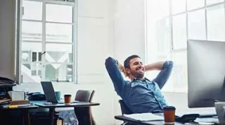 Entspannter Mitarbeiter vor dem PC